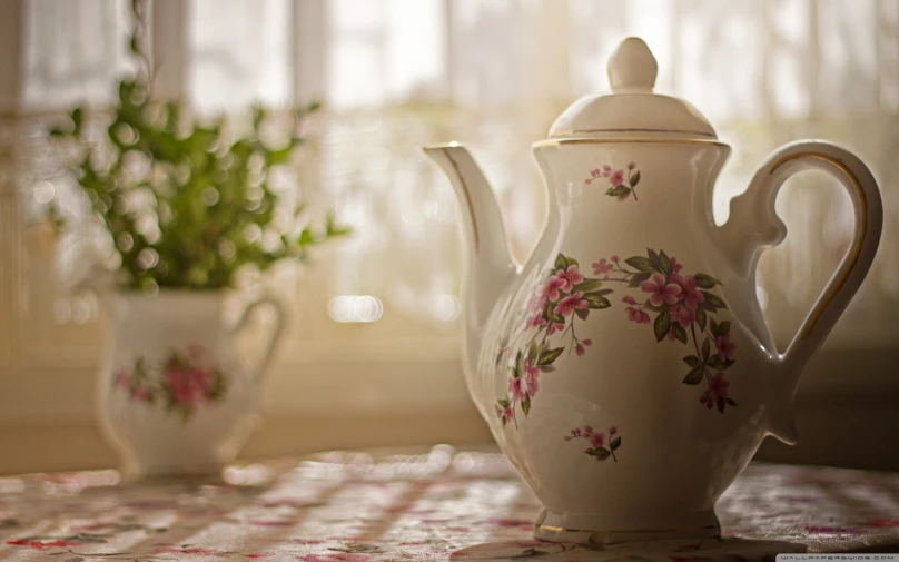 a picture of a teapot with flowers on it