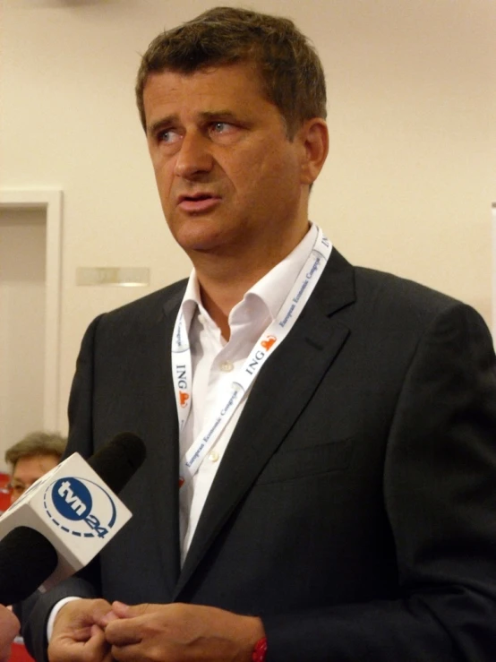 a man speaking into a microphone at an event