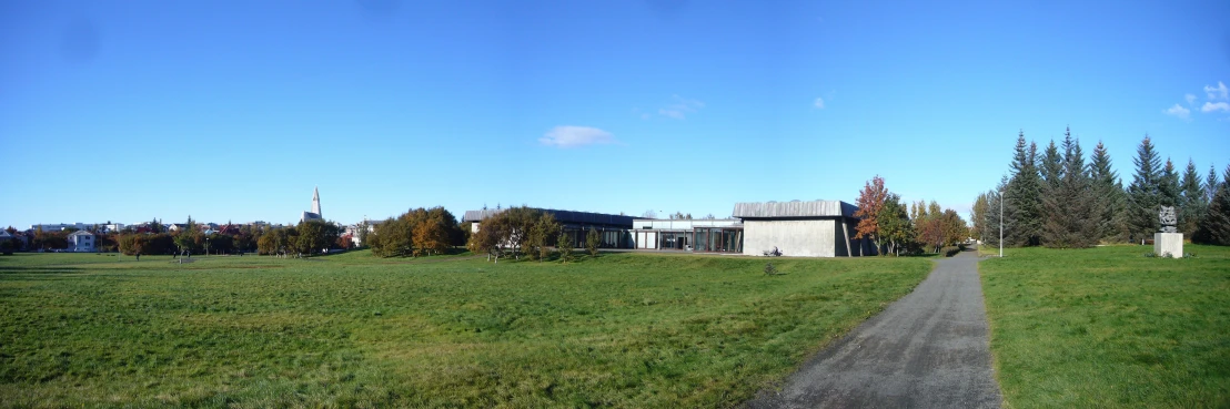 there is a large house on a hill with trees in the background