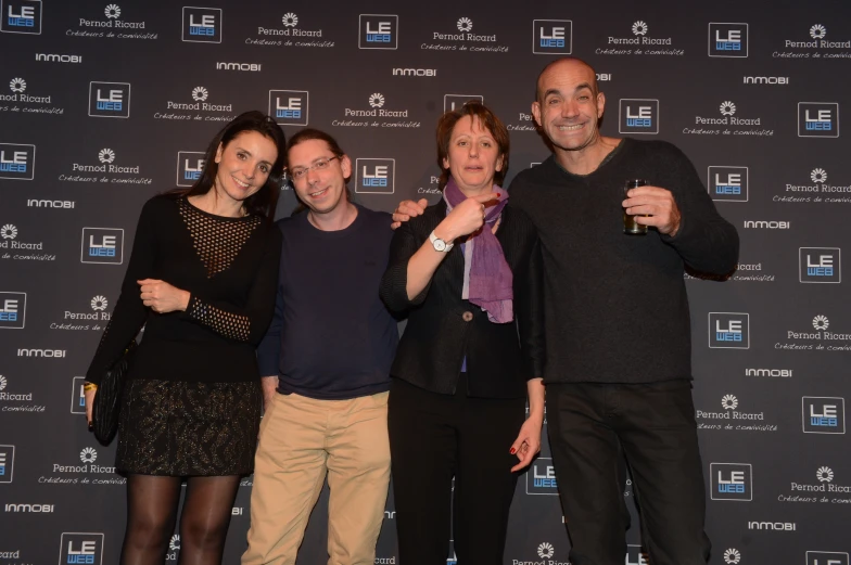 three woman and a man pose for a po