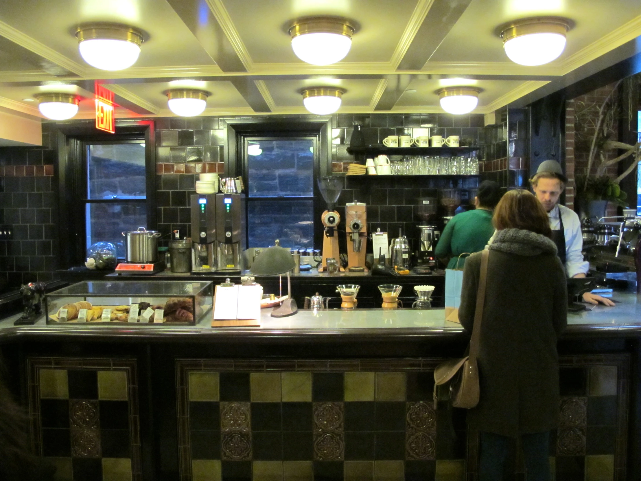 people standing in front of a restaurant counter