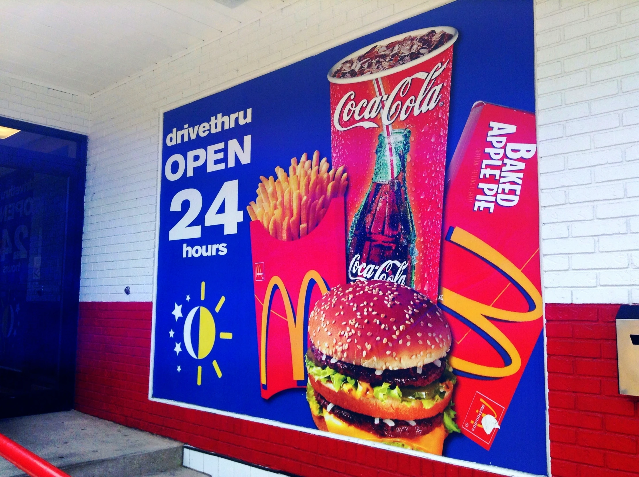 a large advertising sign for a burger and fries