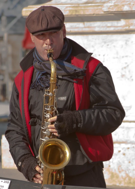 a man playing a saxophone while standing next to another musician