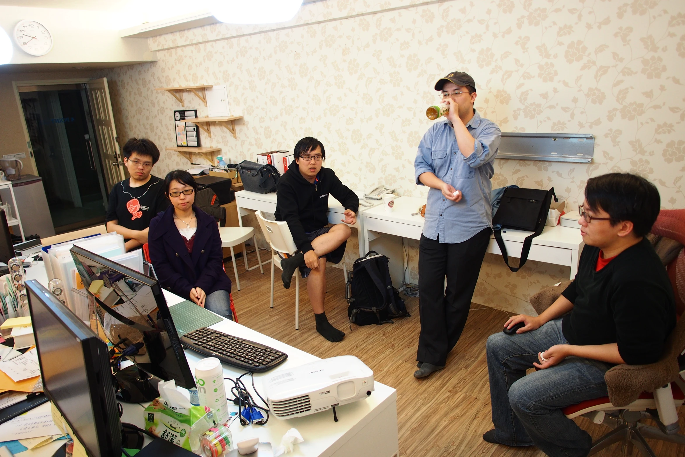 a group of people sitting around computers