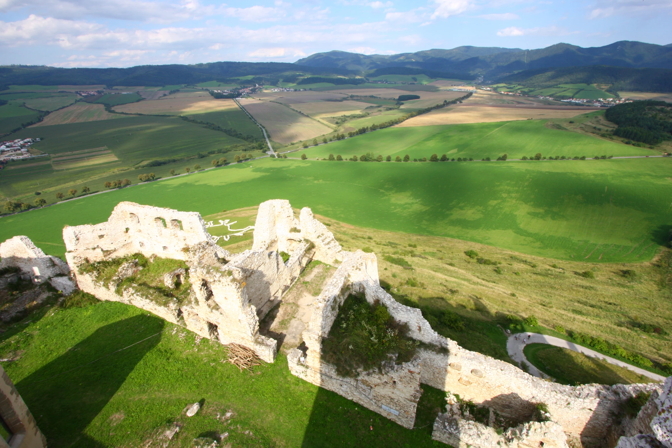 a castle sitting on top of a lush green field