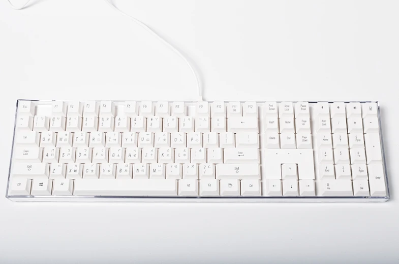 a computer keyboard sitting on top of a white table