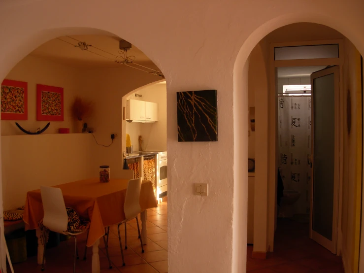the interior view of a home kitchen, through the dining room to the kitchen