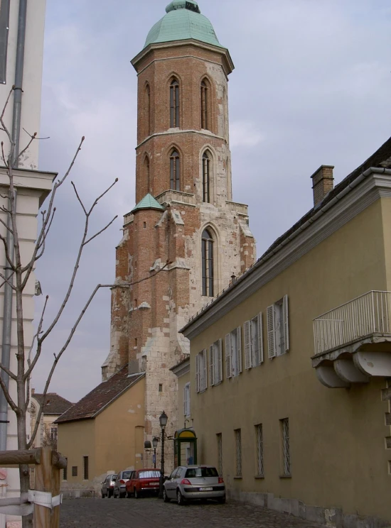 the building with a large tower has a green roof