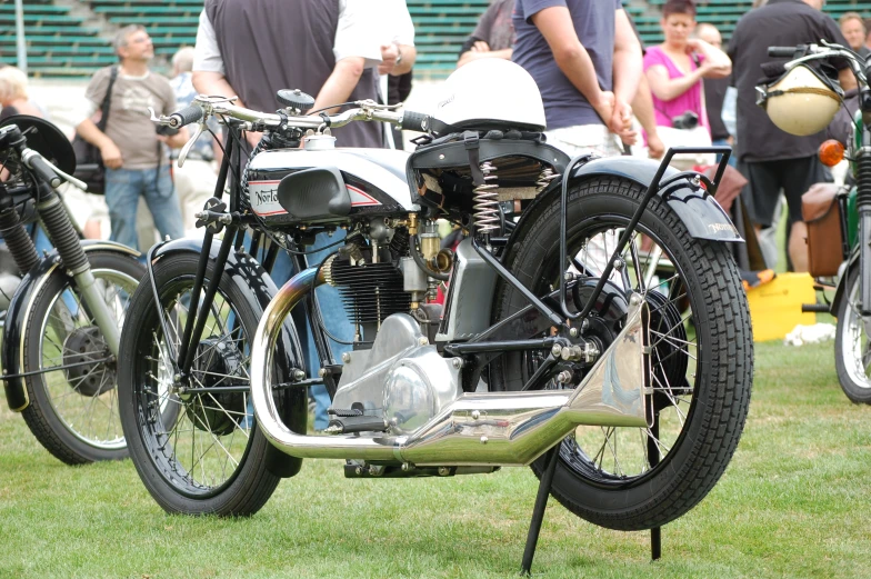 an old school motorcycle is parked at a bike show