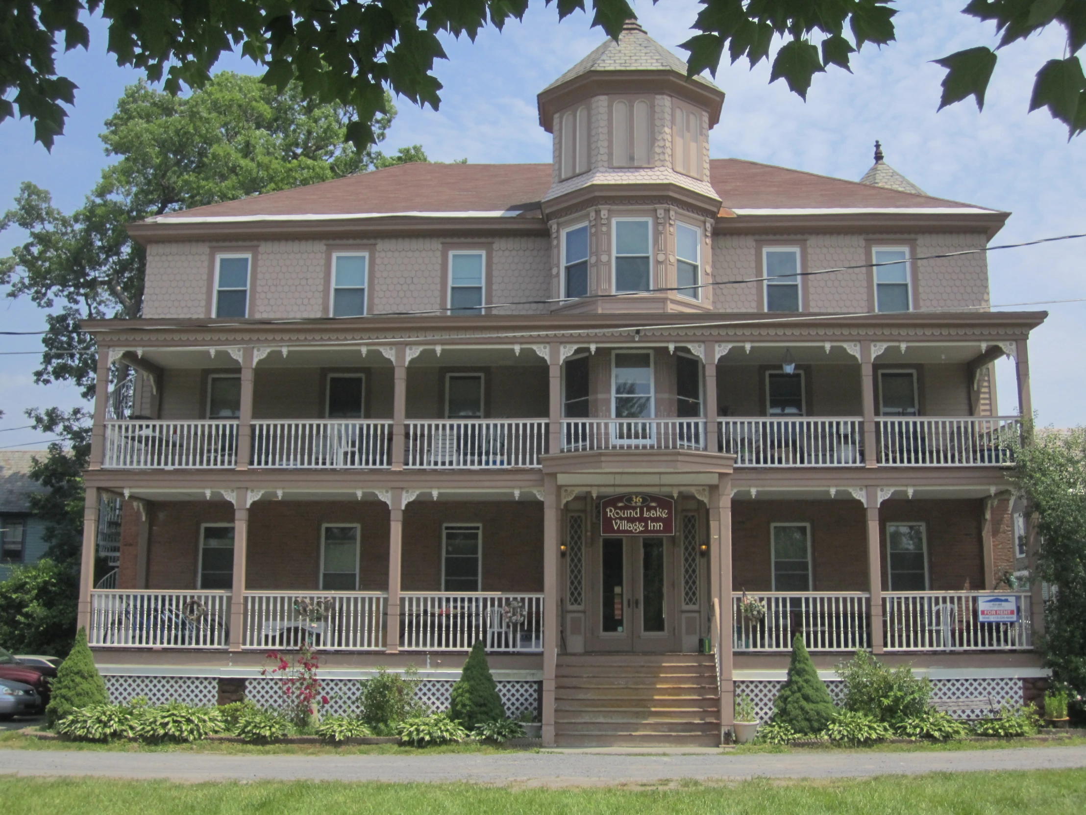 this is a house with two large porches and an upper deck