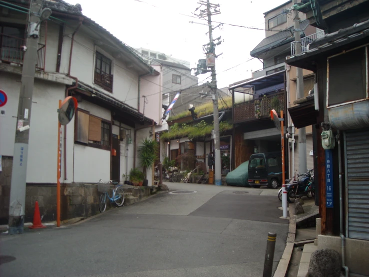 a small village street with parked motorcycles on it