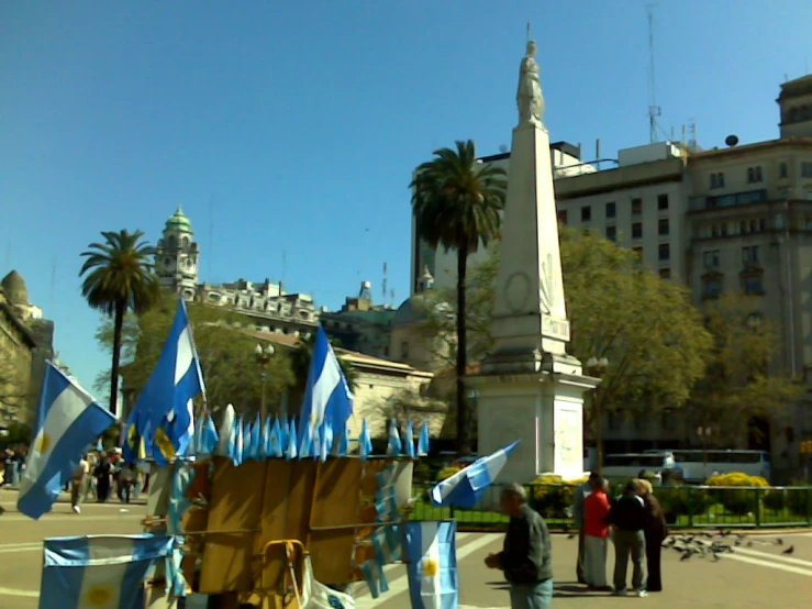 a carnival float with many flags is in the middle of the street