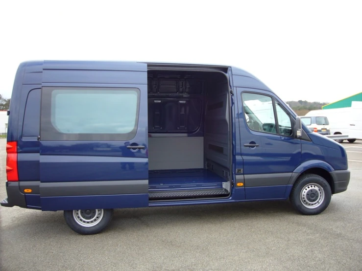 a blue van has its doors open in the parking lot