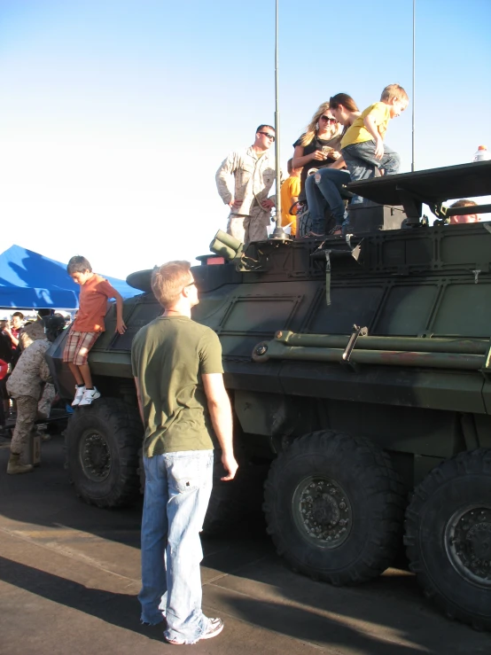 an army truck with people riding on top