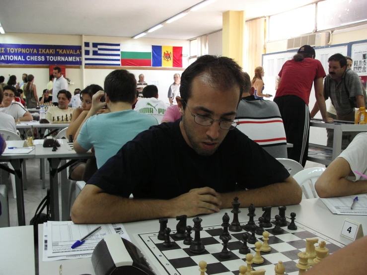 a chess game with two men, one of whom is playing a piece