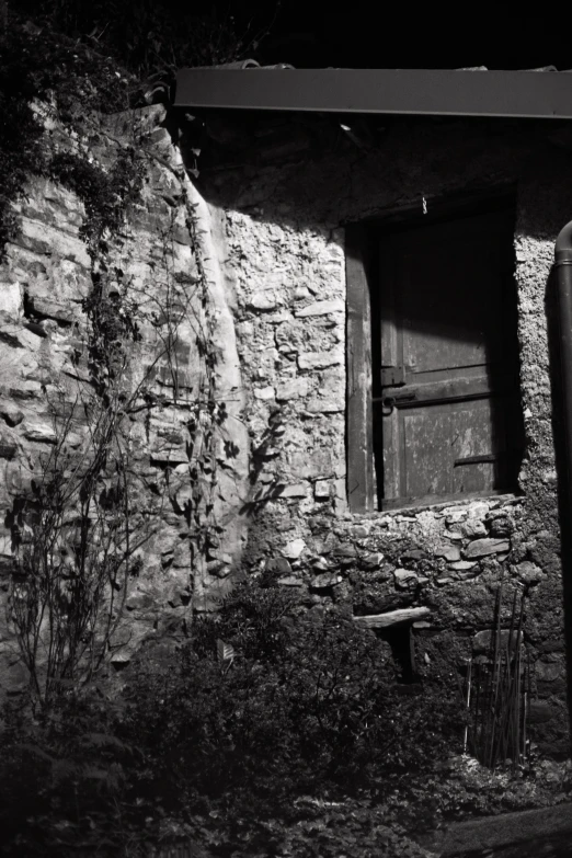 there is an old building made out of stones and wooden doors