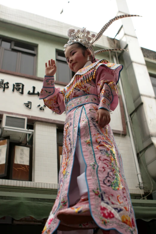 a woman with head dress on, waving