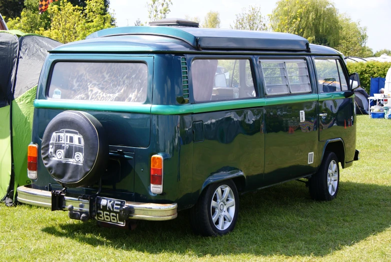 a green van parked in a grass field