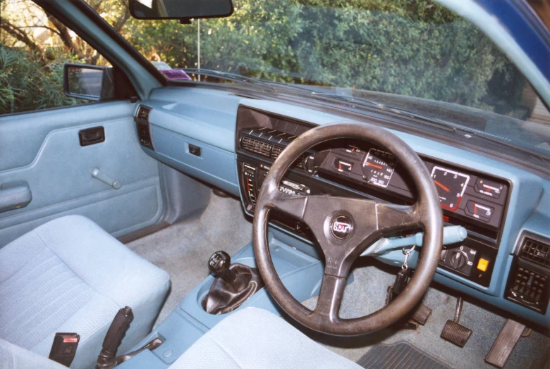 a car interior with steering wheel and dashboard ons