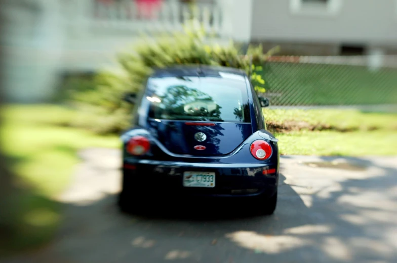 there is a black car parked in the driveway