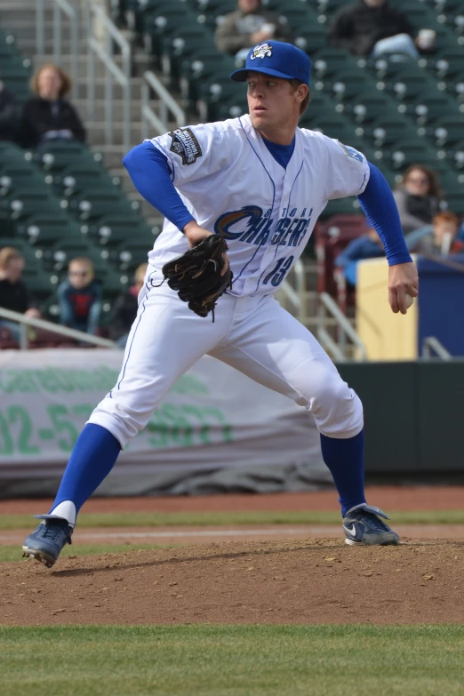 a man playing baseball and looking at the ground