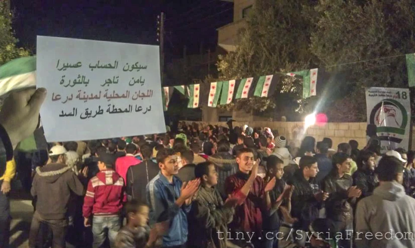 people on a street holding a protest sign