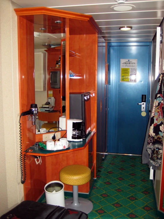 the kitchen has orange cabinetry and white appliances