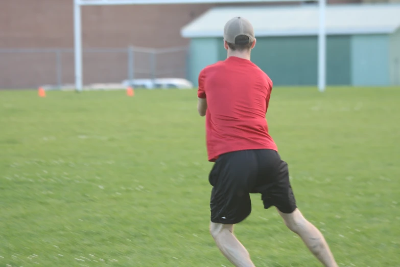 a person playing frisbee in a field