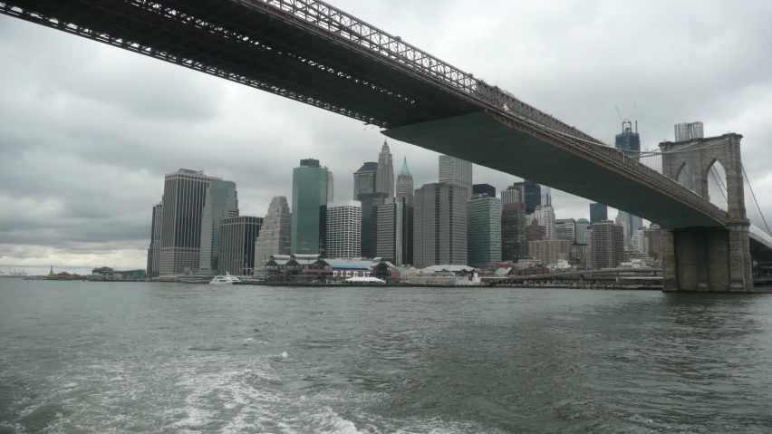 a boat traveling under a bridge on the water