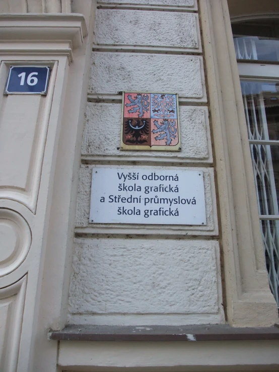 an apartment building with a sign in russian next to the front door