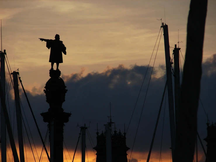 a statue of aham scoll standing on top of a tower