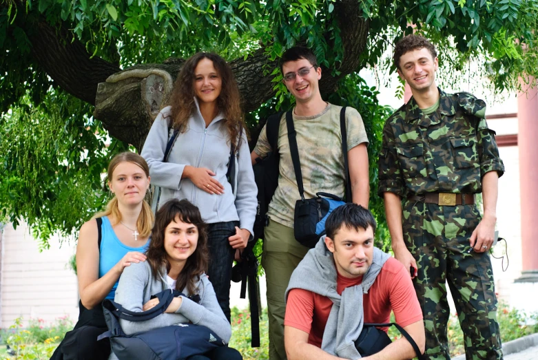 several people are wearing camouflage and standing together