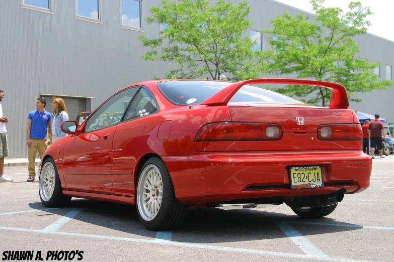 a red sports sedan with lots of chrome rims