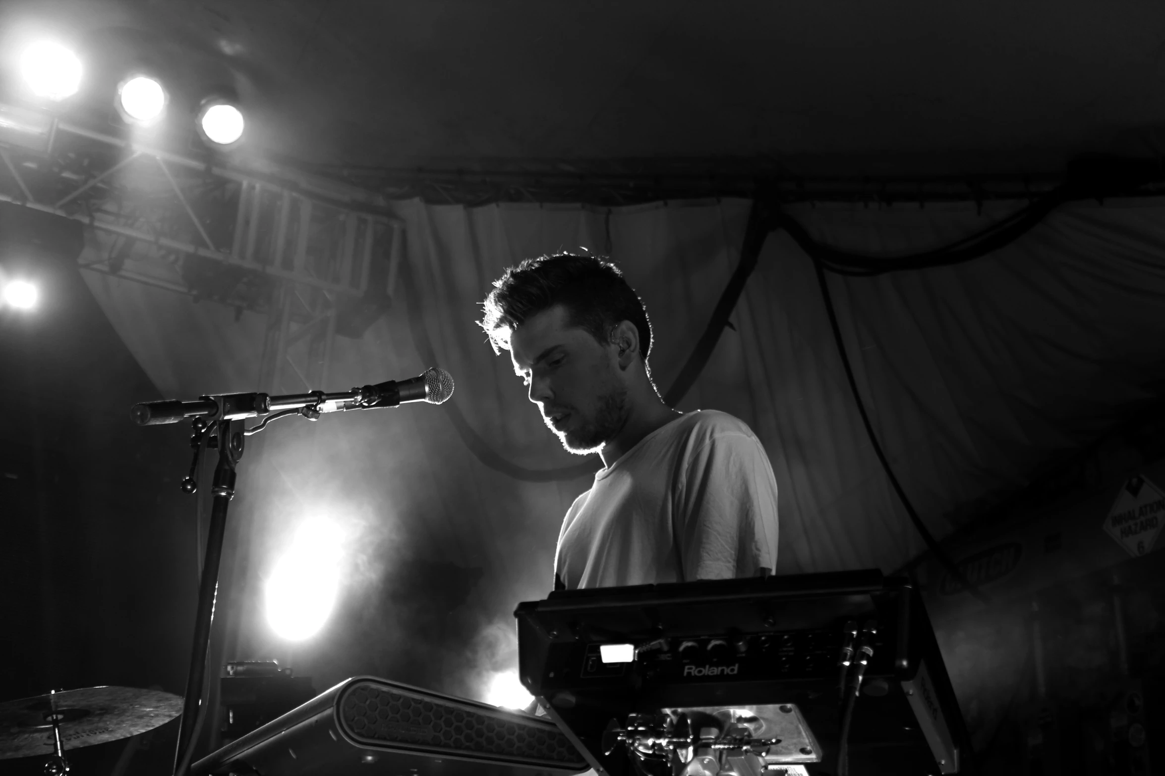 a person playing a sound equipment in front of a microphone