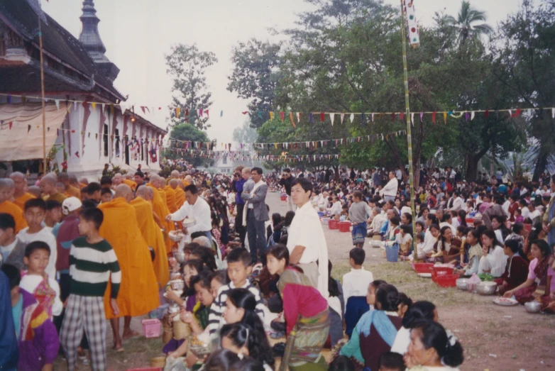 several people are gathered for an outdoor ceremony