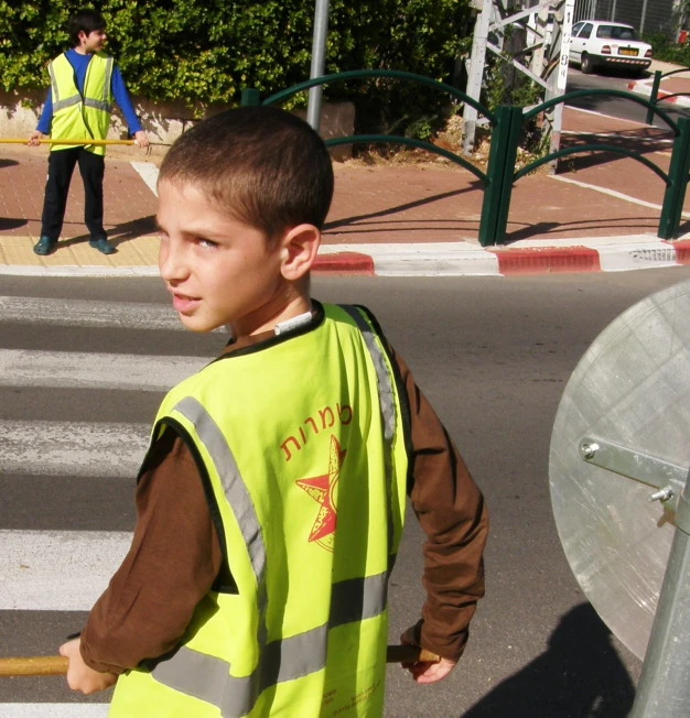 a  wearing safety clothing next to a fire hydrant