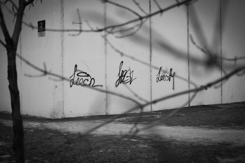 a black and white po of a wall with graffiti