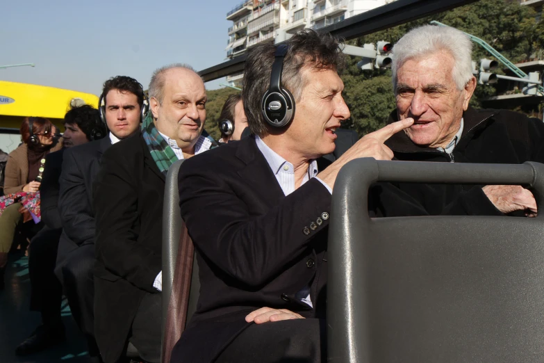 a group of people with headphones standing on top of a street