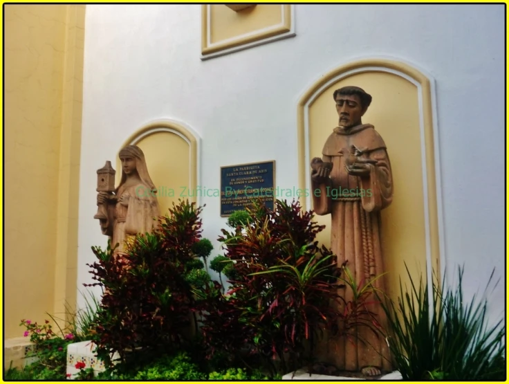 an ornate statue of jesus is shown against a yellow wall