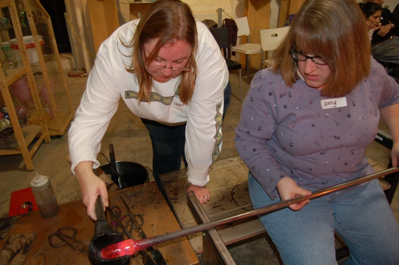 two women working together on a project in a shop