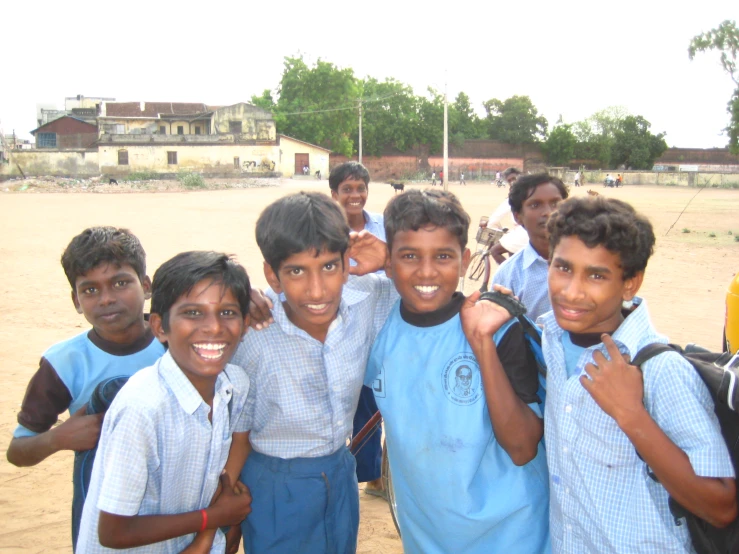 five boys posing together for a po with backpacks