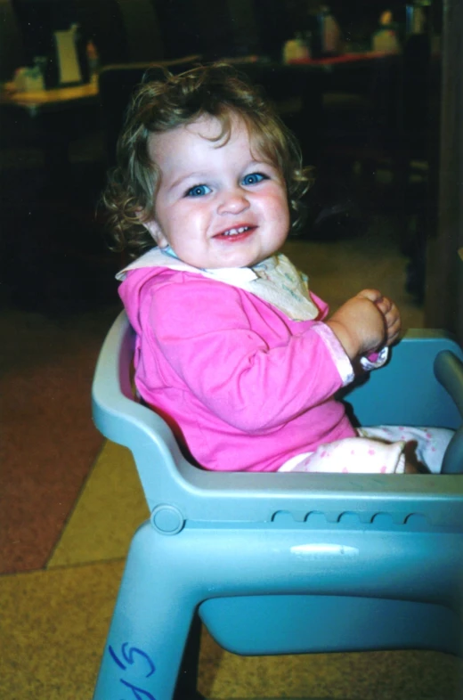 a young child sitting in a baby chair