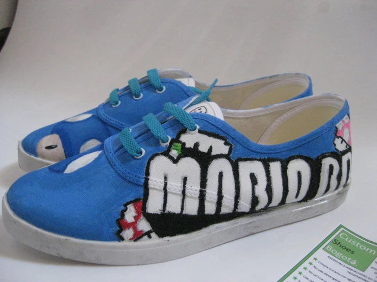a pair of blue shoes with mario bros print