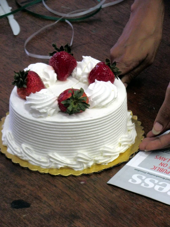 a cake is covered with whipped cream and berries