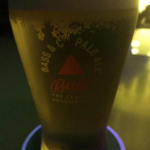 a dark beer being poured in a glass