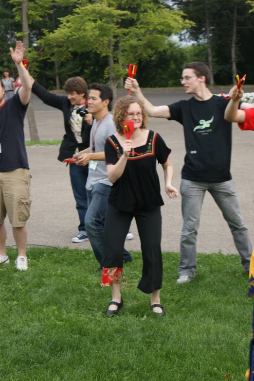 people holding scissors and waving at an event