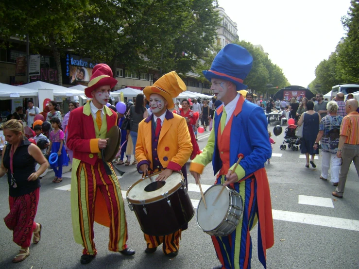 a parade is being observed by men in costume and hats