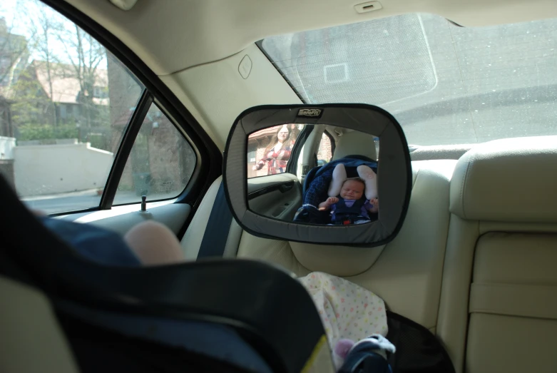 a rear view mirror of a baby in a car