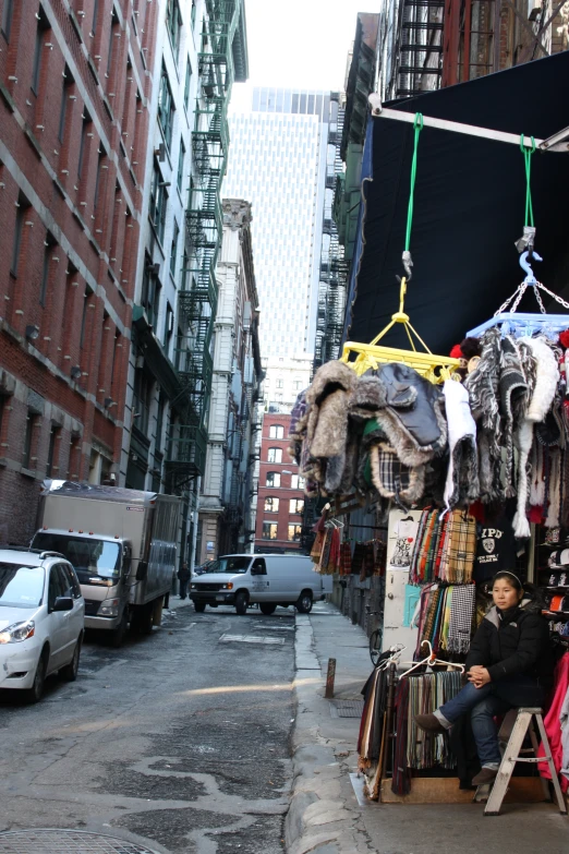 a man looking at clothing displayed in the street