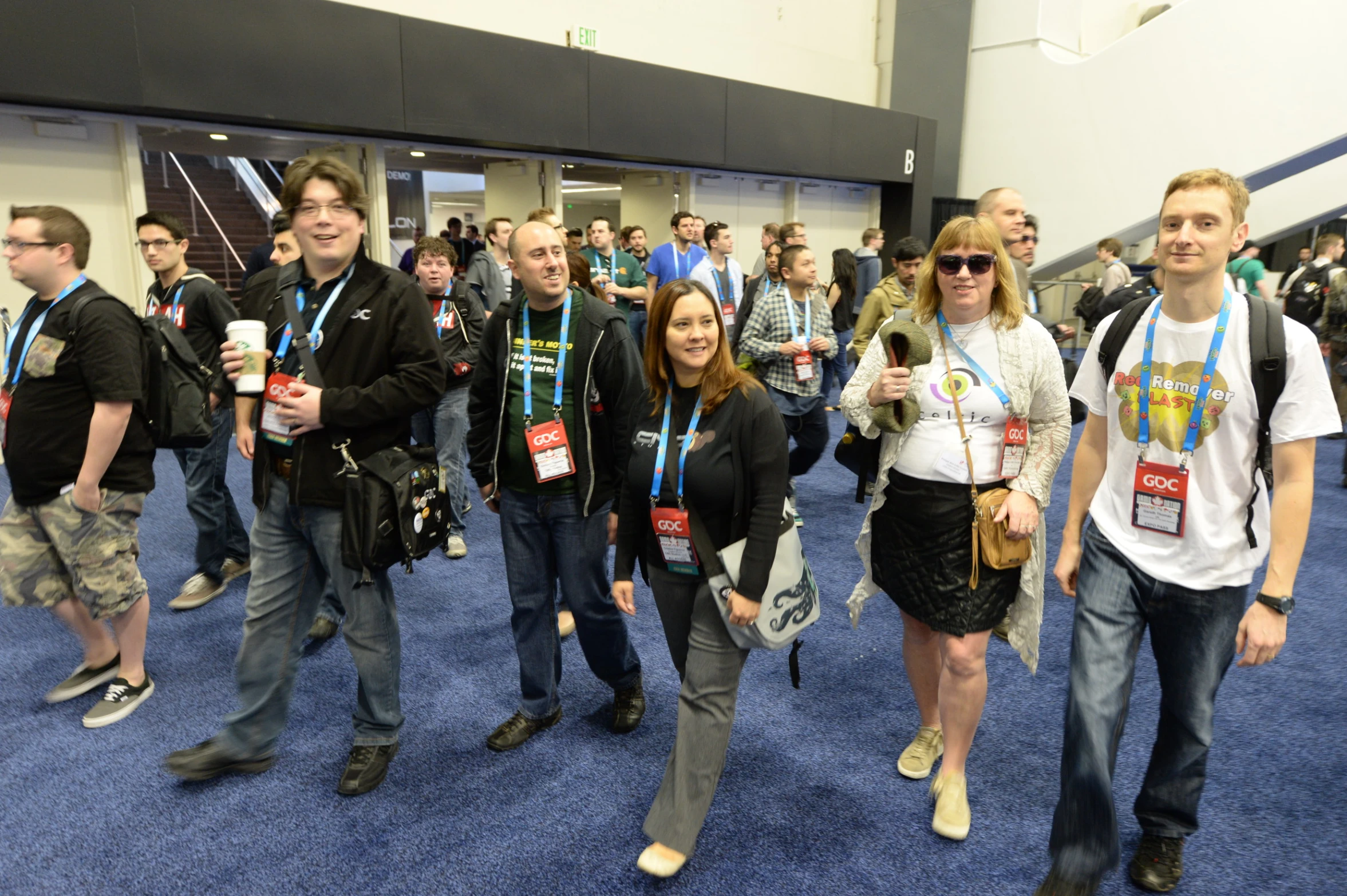 people in a large hall with a bunch of people wearing identios